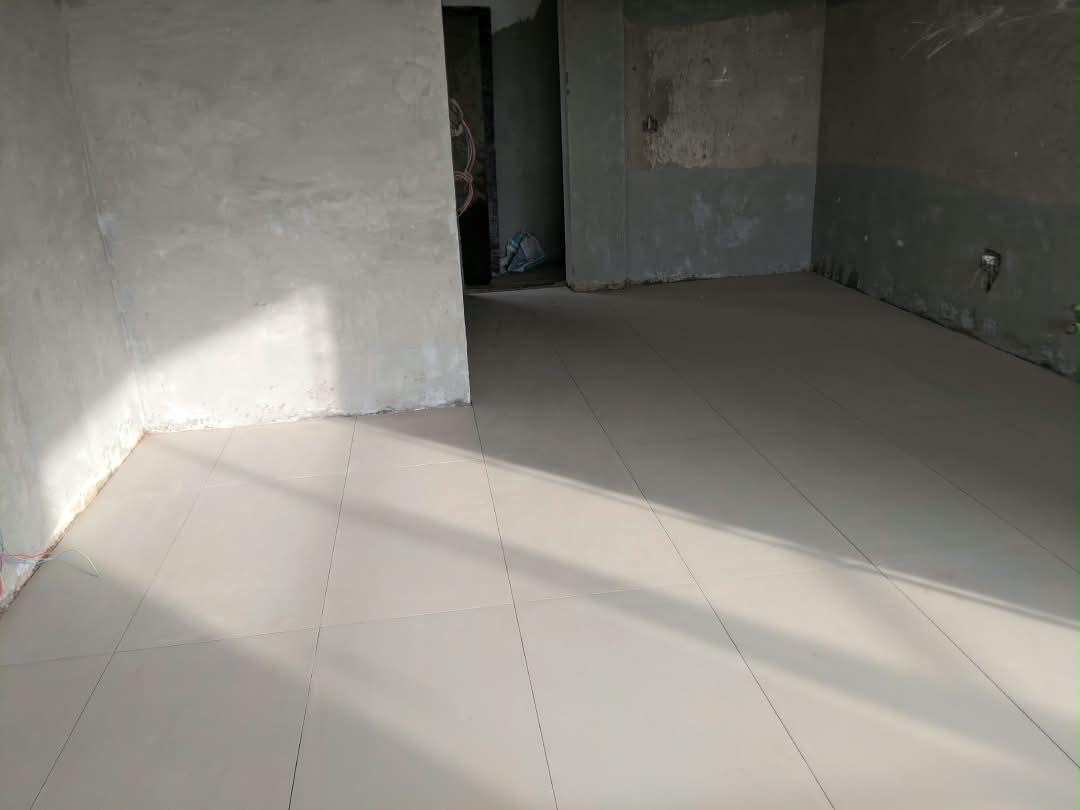 Large-format floor tiles laid in a Dhahabu apartment, September 2026