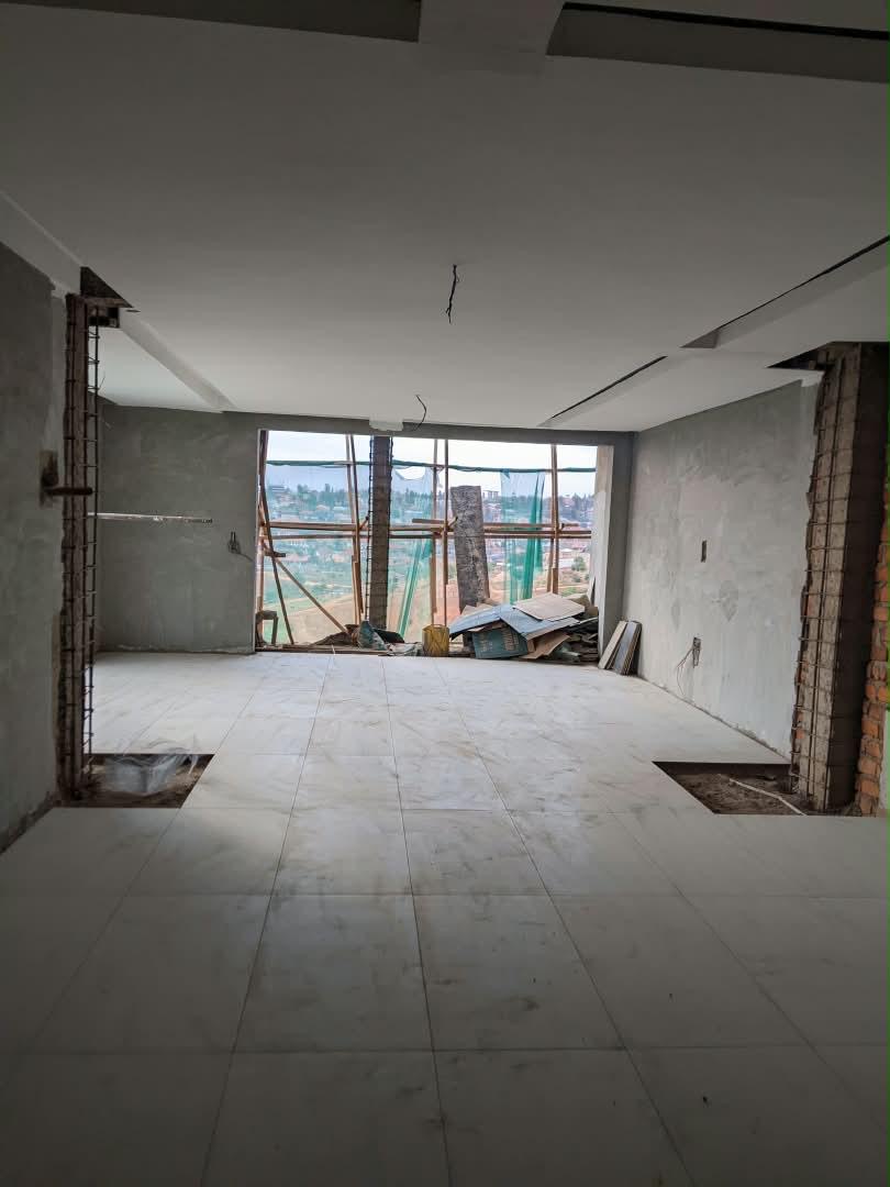 Tiled open-plan living room with hillside views at Dhahabu Apartments, September 2026